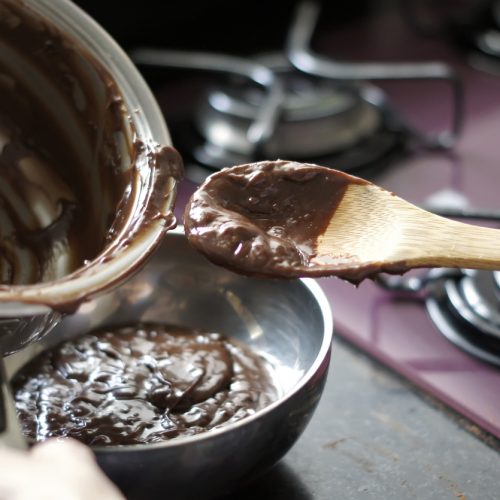 Making chocolate brigadeiro, a typical Brazilian sweet. Defocused background.