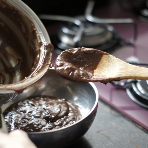 Making chocolate brigadeiro, a typical Brazilian sweet. Defocused background.